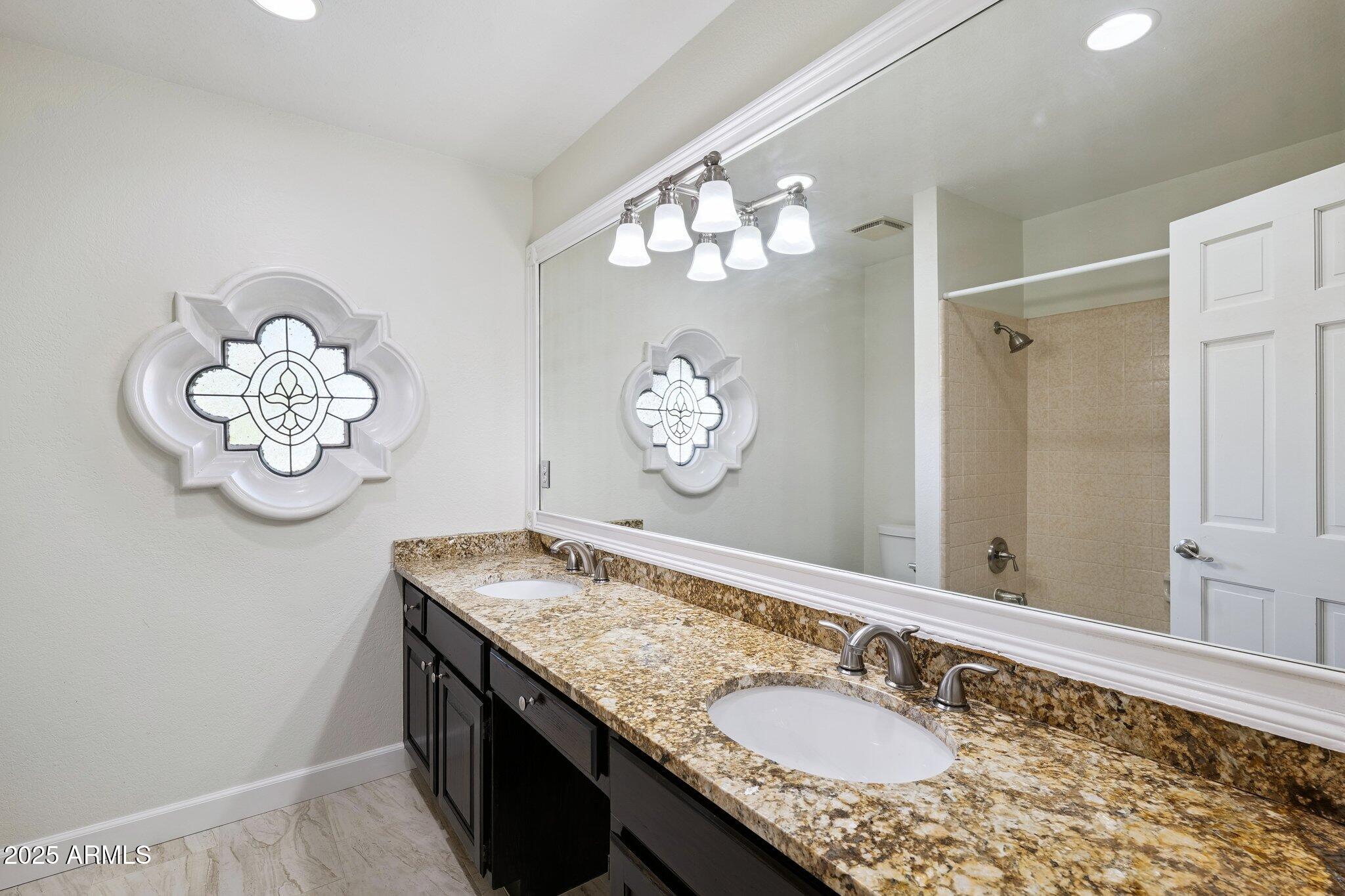 15 East Kathleen Road Phoenix, AZ 85022 - Photo 25 of 40 a bathroom with a granite countertop sink and a mirror