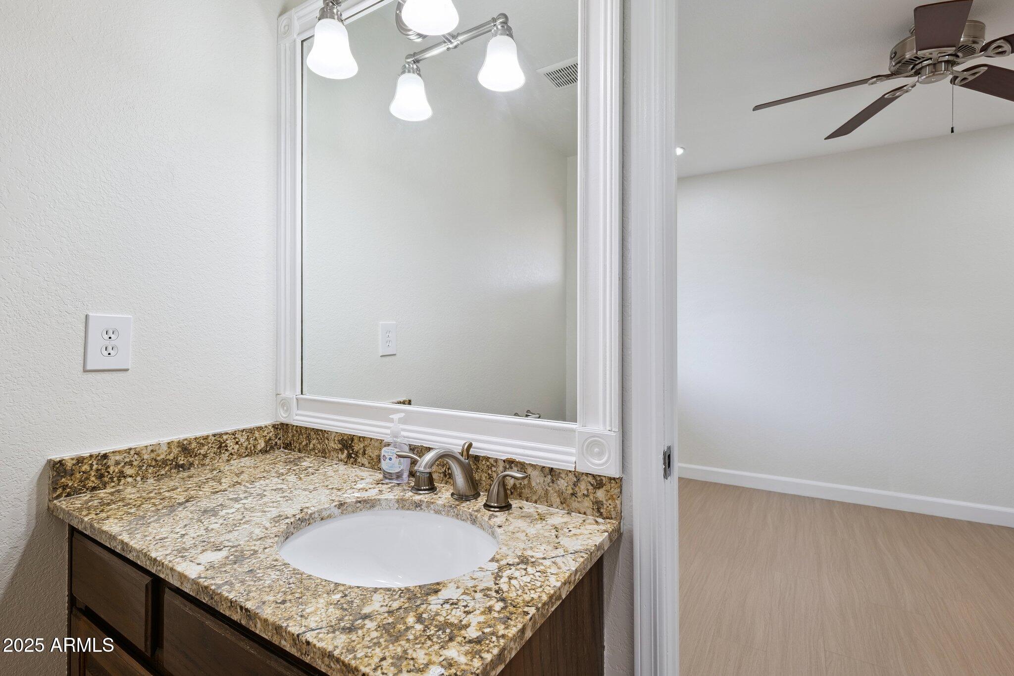 15 East Kathleen Road Phoenix, AZ 85022 - Photo 30 of 40 a bathroom with a granite countertop sink and a mirror