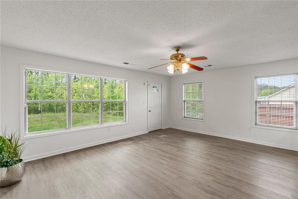3003 Brass Drive Austell, GA 30106 - Photo 11 of 26 a view of an empty room with wooden floor and a window