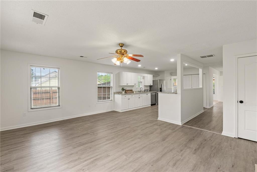 3003 Brass Drive Austell, GA 30106 - Photo 12 of 26 a view of a kitchen with kitchen island wooden floors wooden floor and center island