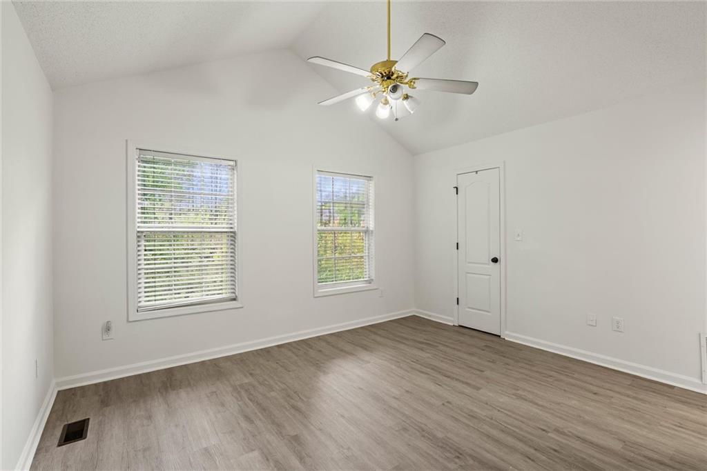 3003 Brass Drive Austell, GA 30106 - Photo 13 of 26 a view of an empty room with wooden floor and a window