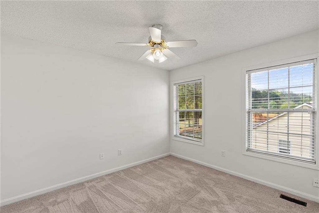 3003 Brass Drive Austell, GA 30106 - Photo 18 of 26 an empty room with windows and fan