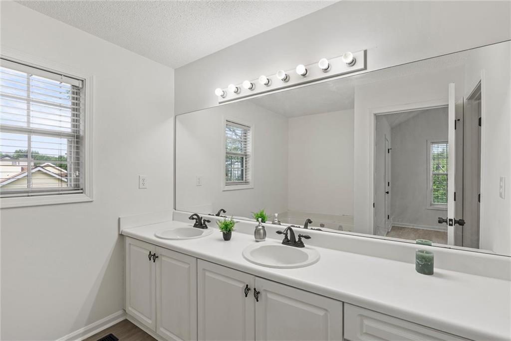 3003 Brass Drive Austell, GA 30106 - Photo 19 of 26 a bathroom with a sink and a mirror