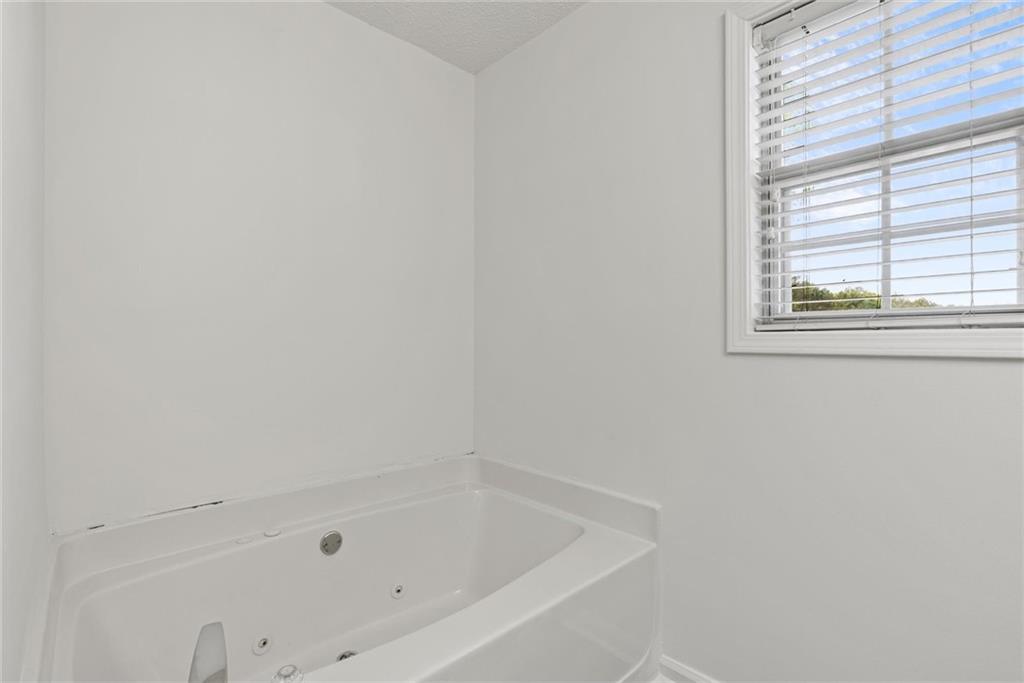 3003 Brass Drive Austell, GA 30106 - Photo 20 of 26 a white bath tub sitting next to a window