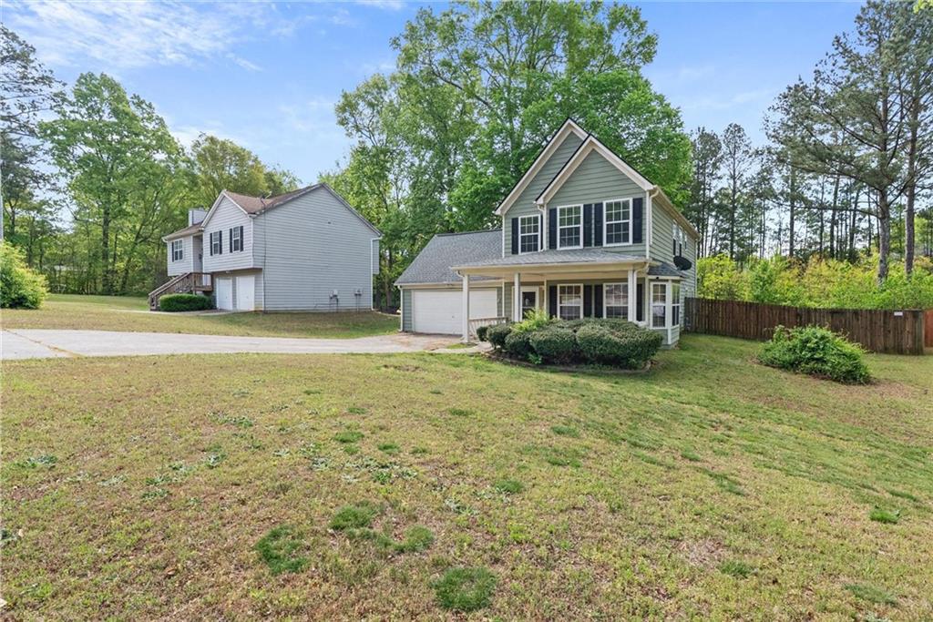3003 Brass Drive Austell, GA 30106 - Photo 2 of 26 a front view of a house with yard and green space
