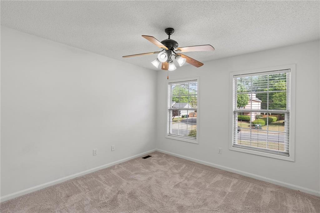 3003 Brass Drive Austell, GA 30106 - Photo 22 of 26 an empty room with windows and fan
