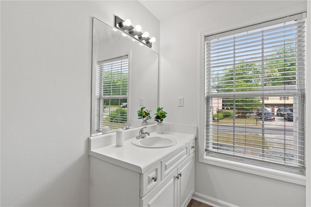 3003 Brass Drive Austell, GA 30106 - Photo 23 of 26 a bathroom with a sink a mirror and a window