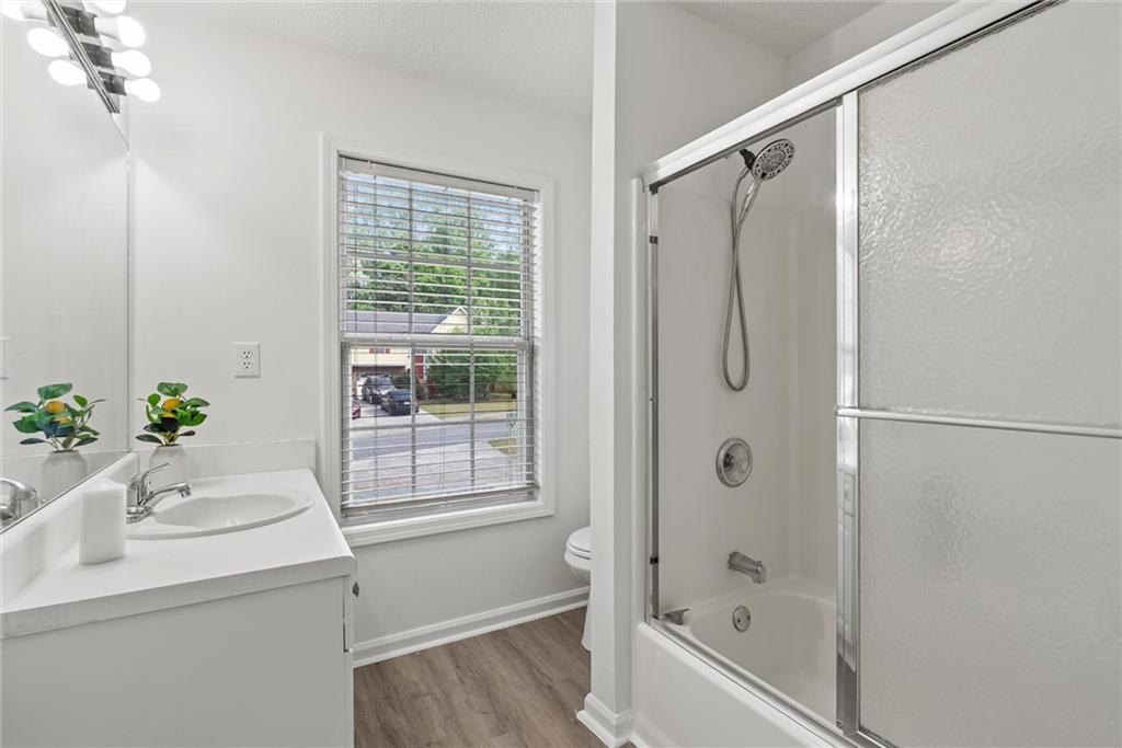 3003 Brass Drive Austell, GA 30106 - Photo 24 of 26 a bathroom with a bathtub a shower and a sink