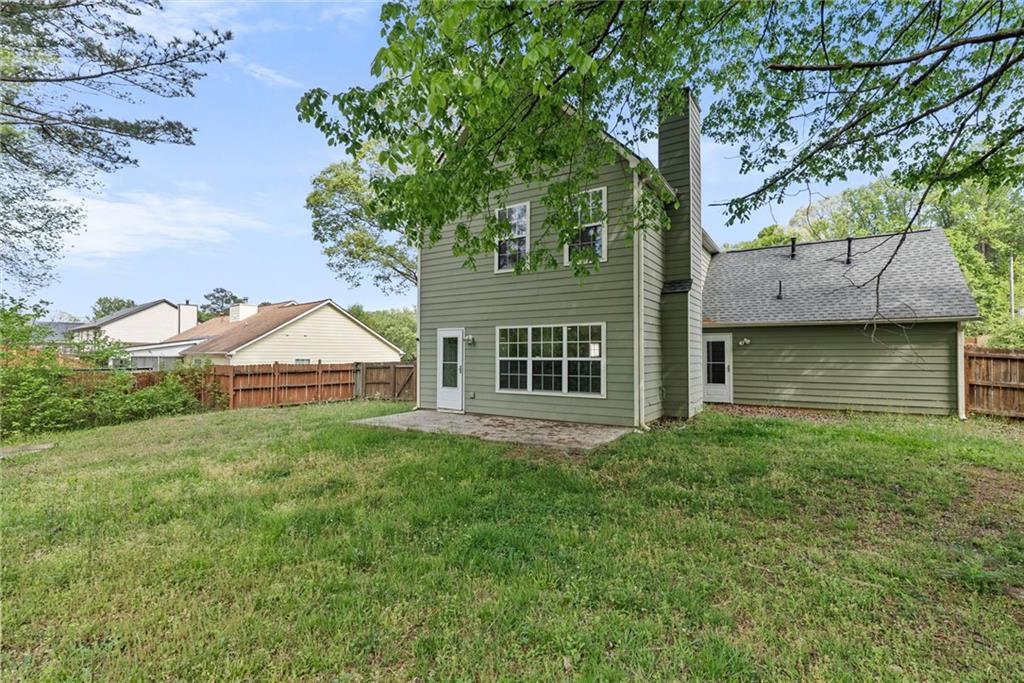 3003 Brass Drive Austell, GA 30106 - Photo 26 of 26 a front view of a house with a yard and trees
