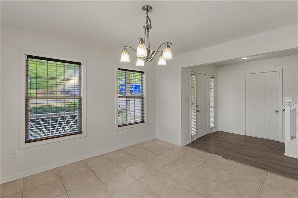 3003 Brass Drive Austell, GA 30106 - Photo 4 of 26 a view of an empty room with a window and wooden floor