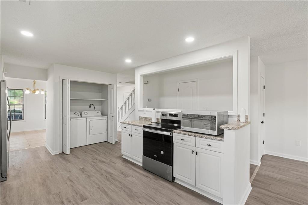 3003 Brass Drive Austell, GA 30106 - Photo 6 of 26 a kitchen with a stove top oven and refrigerator