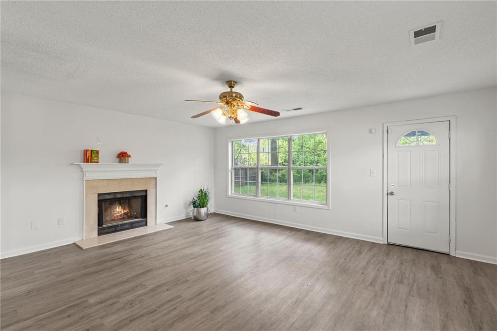 3003 Brass Drive Austell, GA 30106 - Photo 9 of 26 a view of an empty room with wooden floor fireplace and a window