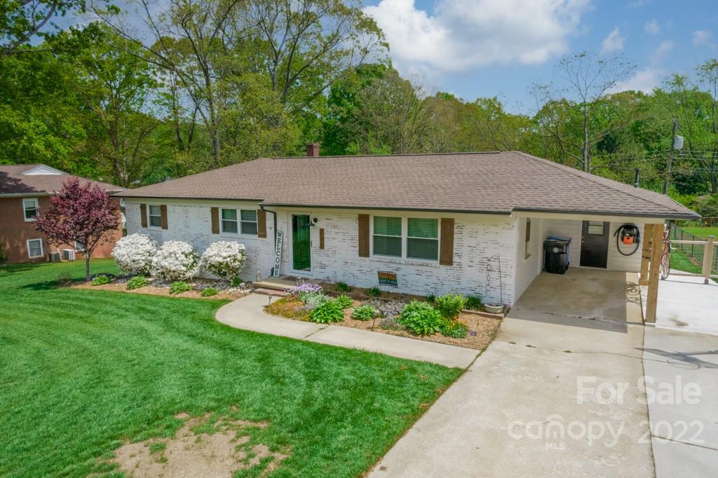 338 Fieldstone Road Mooresville, NC 28115 - Photo 3 of 37 a front view of a house with a garden and porch