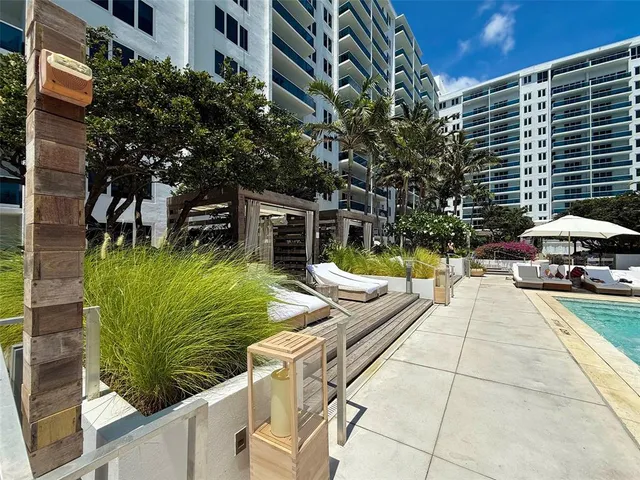 a view of a patio with couches table and chairs and potted plants