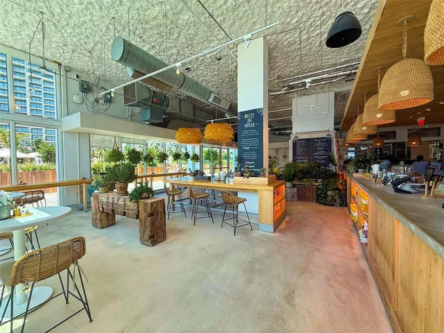 a view of a patio with a dining table and chairs under an umbrella