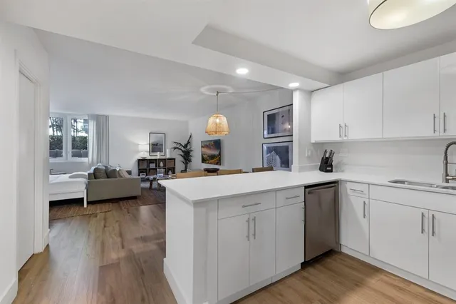 a kitchen with a sink a counter top space and cabinets
