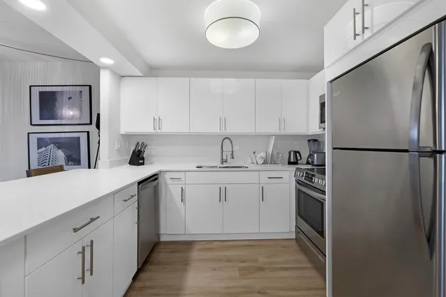 a kitchen with a sink stainless steel appliances and cabinets