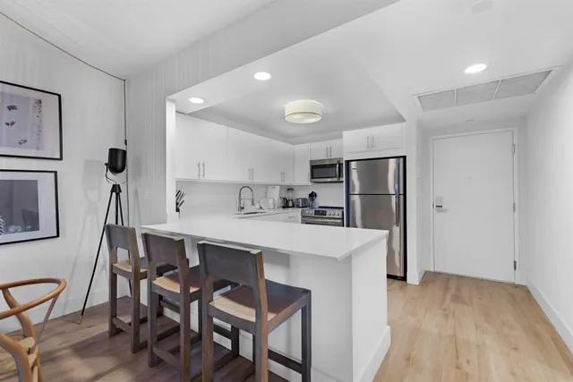 a kitchen with stainless steel appliances a sink and a refrigerator