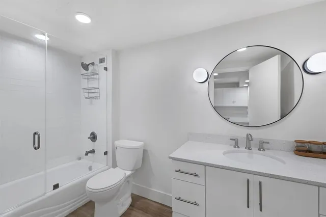 a bathroom with a sink a toilet and a mirror