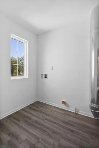a view of a room with wooden floor and window