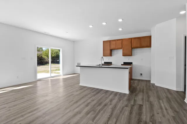 a view of kitchen with sink and wooden floor