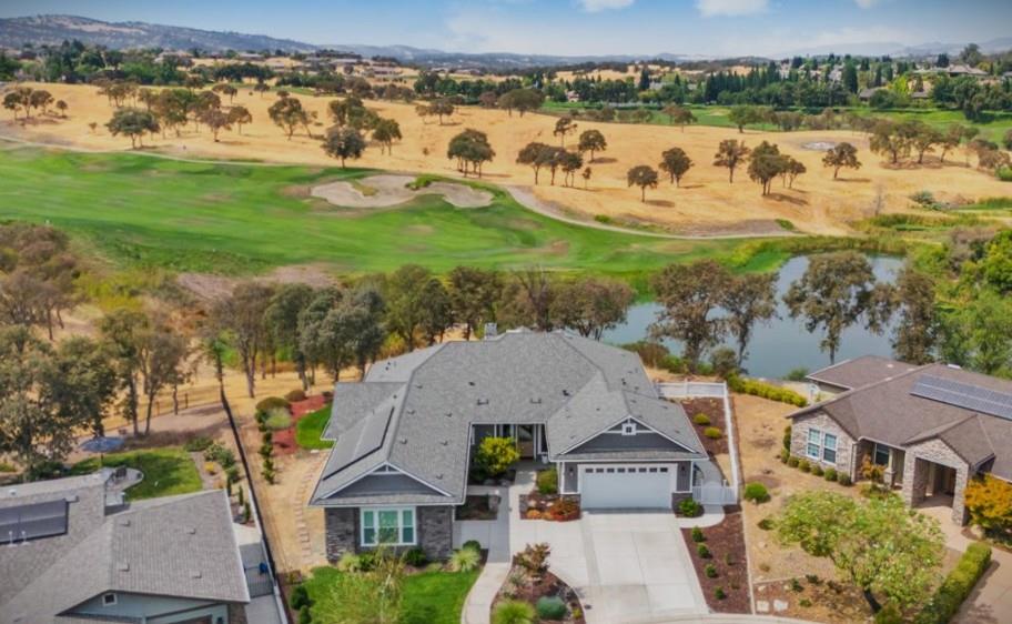 an aerial view of residential houses with outdoor space and ocean view
