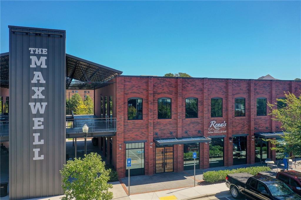 1395 Mid Broadwell Road Alpharetta, GA 30004 - Photo 32 of 67 a view of a brick building with many windows and yard