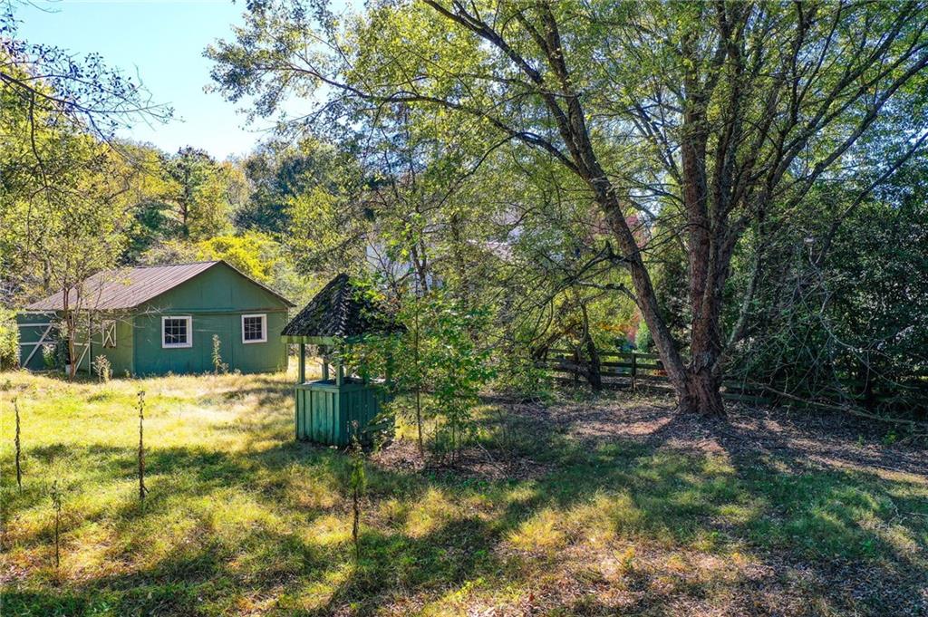 1395 Mid Broadwell Road Alpharetta, GA 30004 - Photo 5 of 67 a yellow house in the middle of a yard