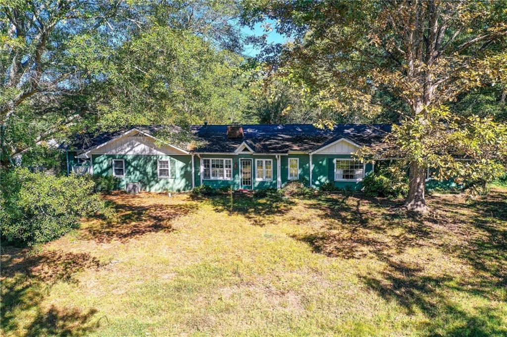 1395 Mid Broadwell Road Alpharetta, GA 30004 - Photo 6 of 67 a front view of a house with a yard