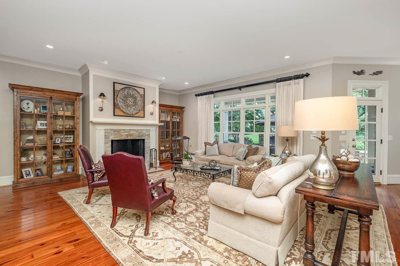 2129 Buckingham Road Raleigh, NC 27607 - Photo 13 of 52 a living room with furniture large window and fireplace