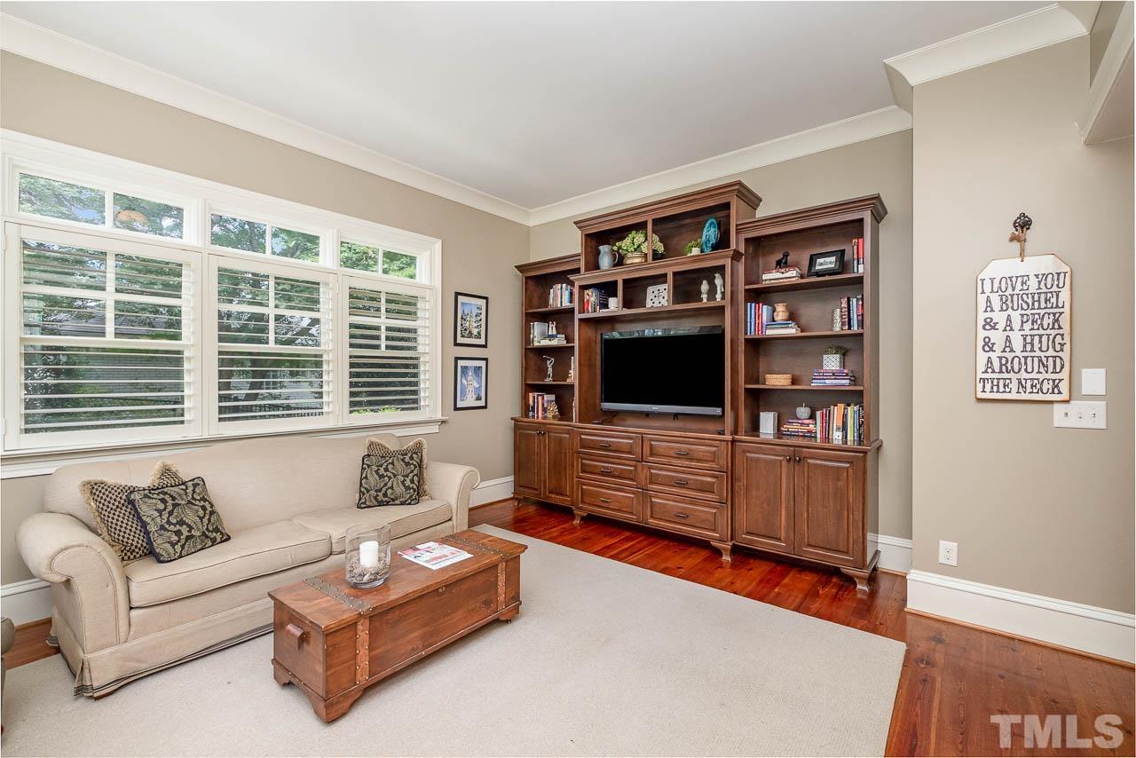 2129 Buckingham Road Raleigh, NC 27607 - Photo 17 of 52 a living room with furniture and a flat screen tv