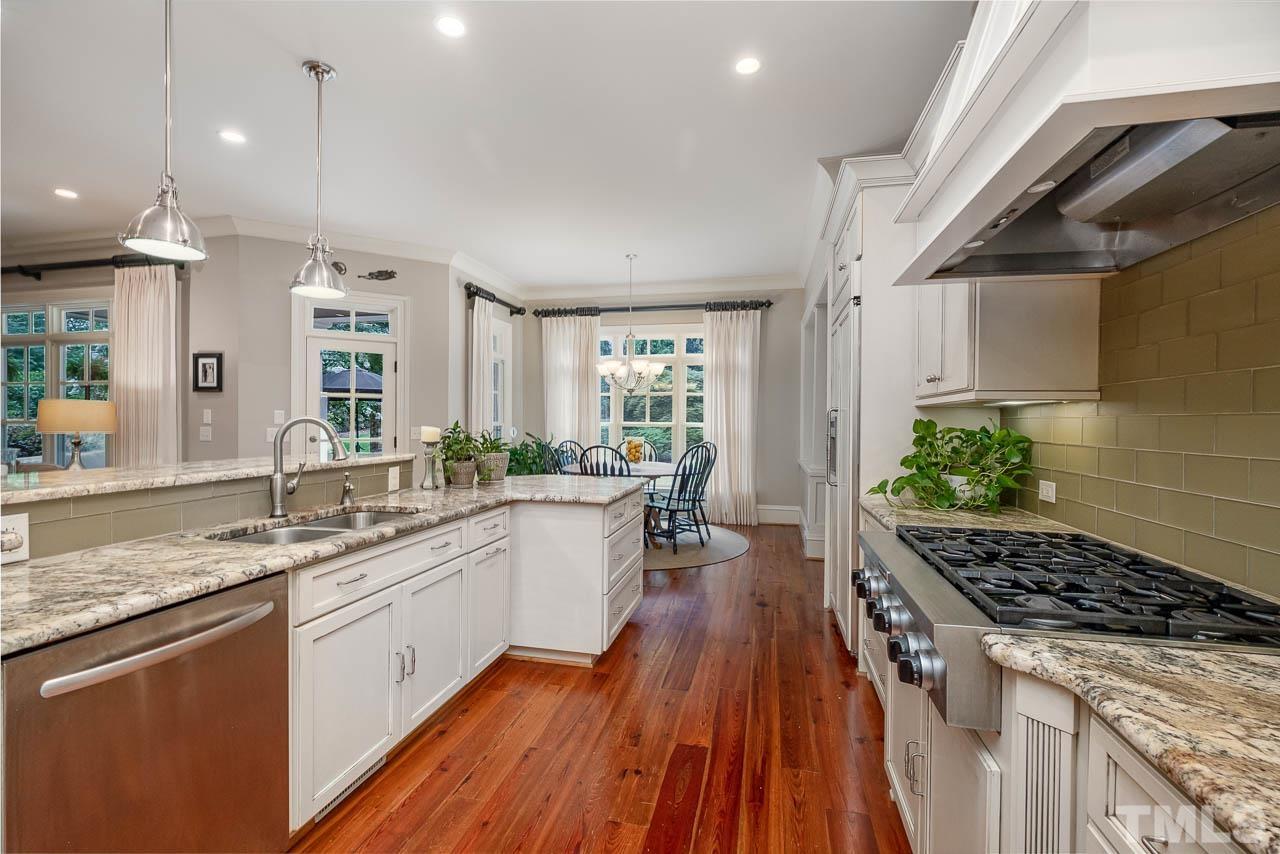 2129 Buckingham Road Raleigh, NC 27607 - Photo 22 of 52 a kitchen with sink stove and refrigerator