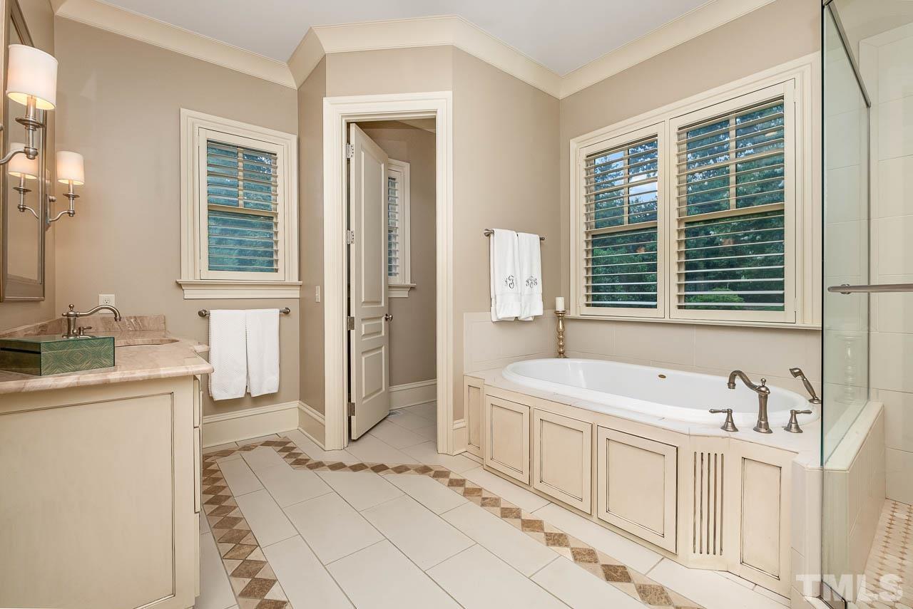 2129 Buckingham Road Raleigh, NC 27607 - Photo 31 of 52 a spacious bathroom with a tub sink and mirror