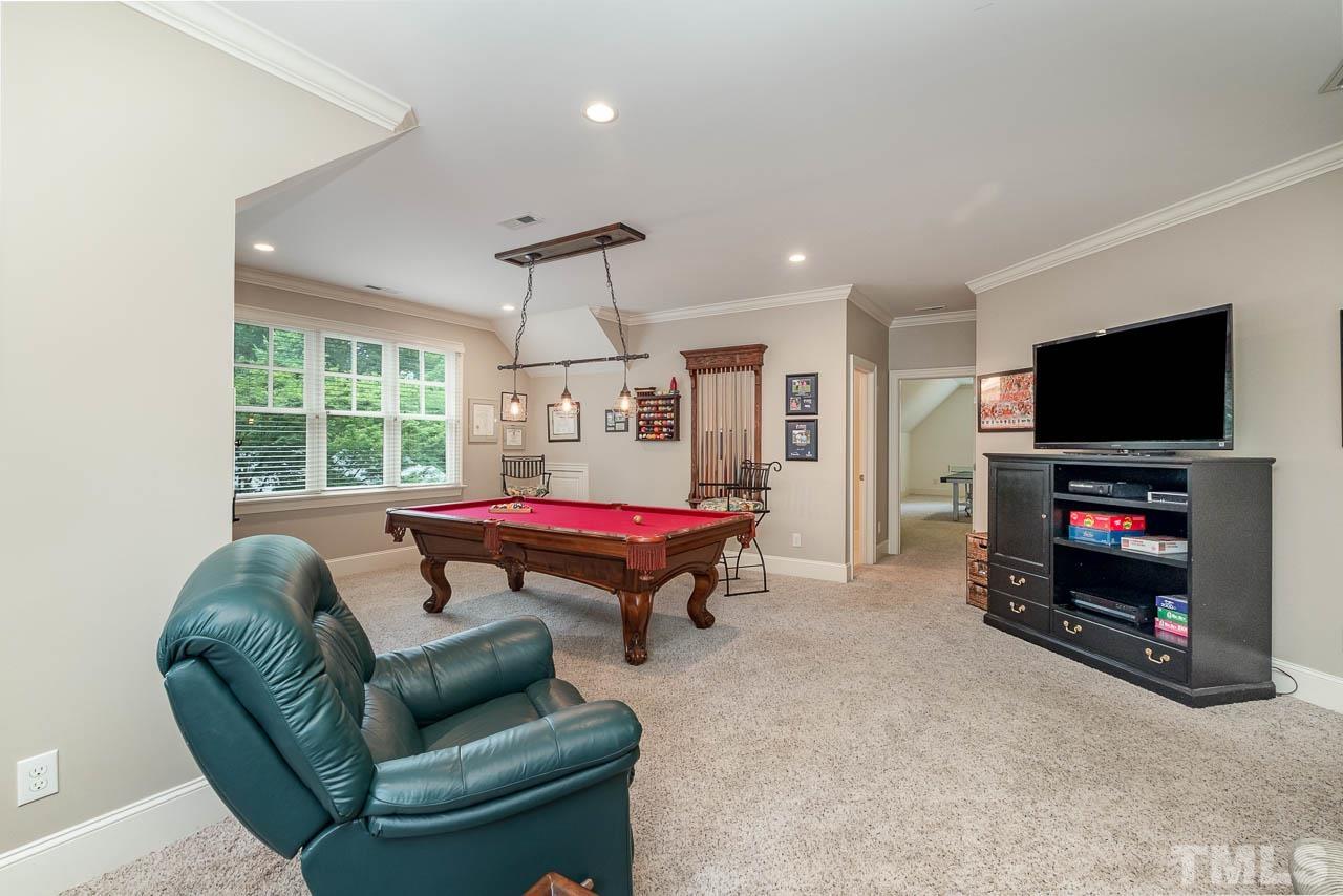 2129 Buckingham Road Raleigh, NC 27607 - Photo 35 of 52 a living room with furniture and a flat screen tv