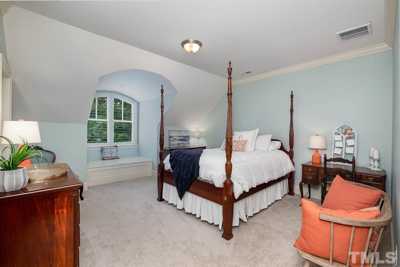 2129 Buckingham Road Raleigh, NC 27607 - Photo 41 of 52 a spacious bedroom with a bed and a window