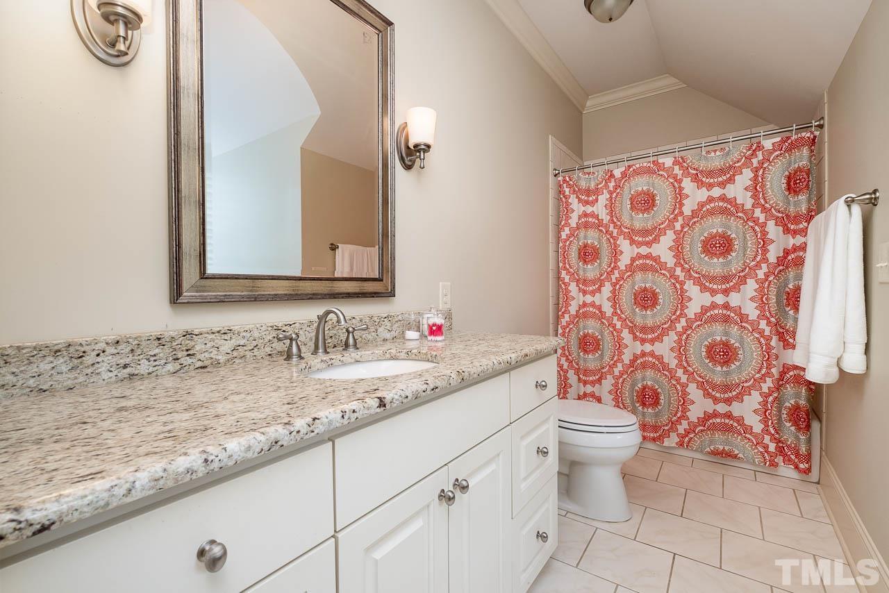 2129 Buckingham Road Raleigh, NC 27607 - Photo 43 of 52 a bathroom with a granite countertop sink a toilet and a mirror