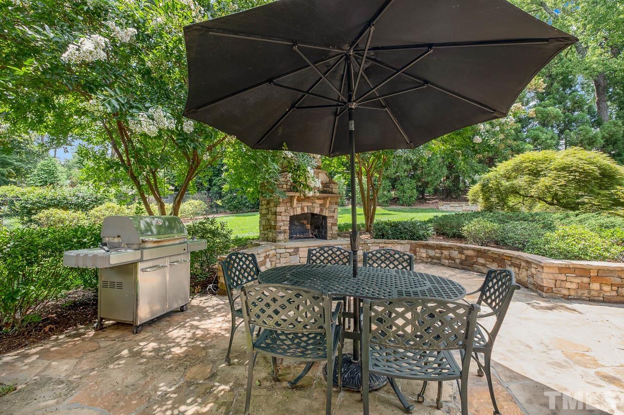 2129 Buckingham Road Raleigh, NC 27607 - Photo 9 of 52 a patio with a patio table and chairs