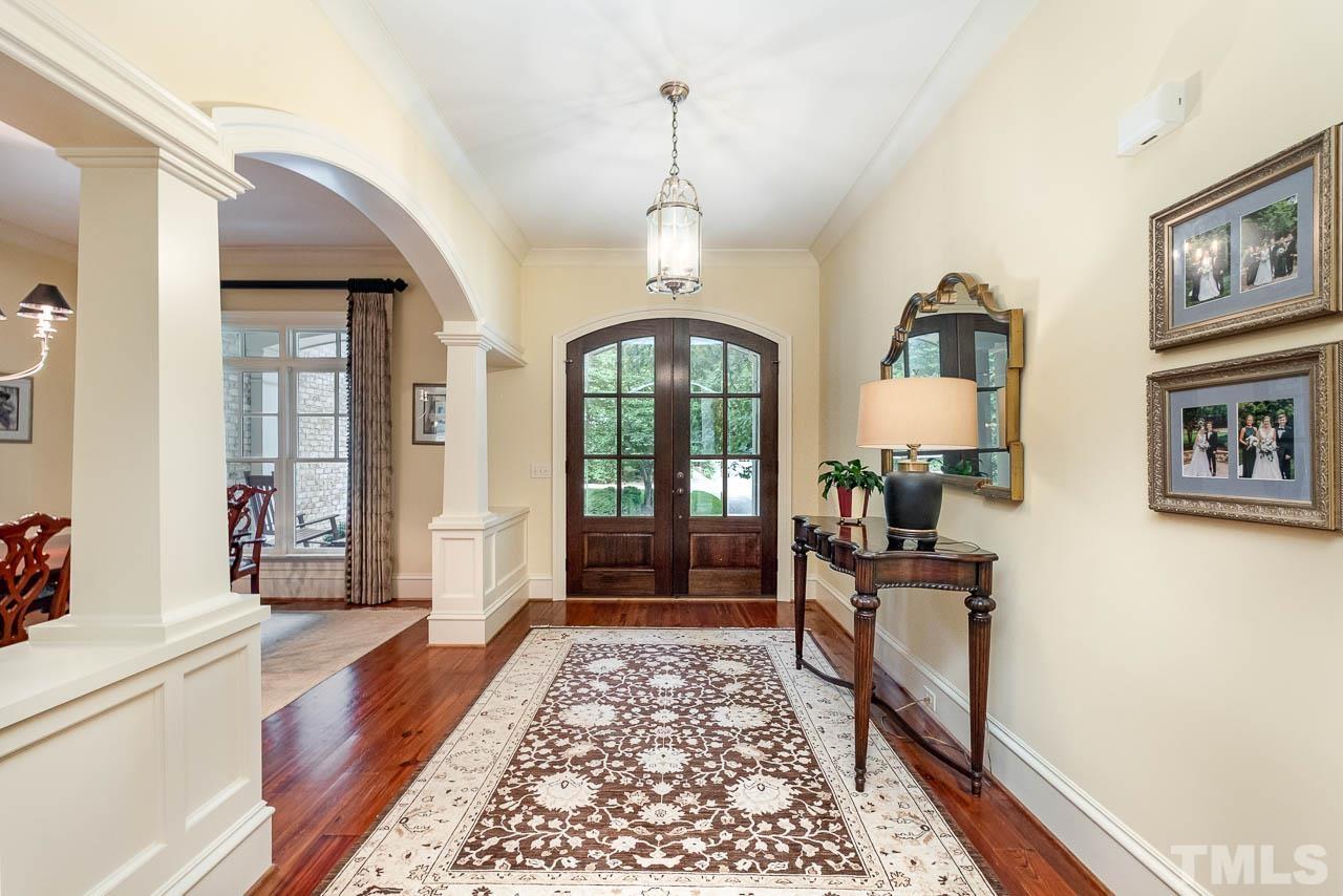 2129 Buckingham Road Raleigh, NC 27607 - Photo 10 of 52 a view of a hallway with wooden floor and a living room