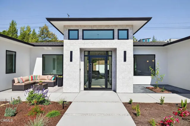 a front view of a house with garden