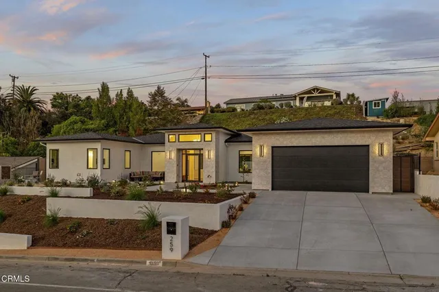 a living room with furniture a dining table and a large window with garden view