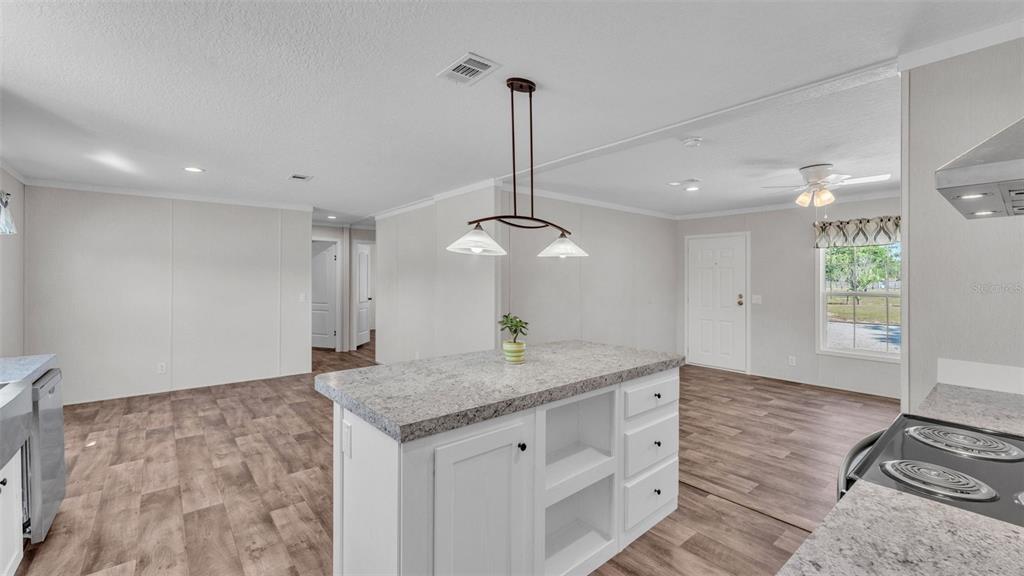 5535 Lake Buffum Road Lake Wales, FL 33859 - Photo 12 of 48 a kitchen with stainless steel appliances granite countertop a sink a refrigerator and a granite counter tops