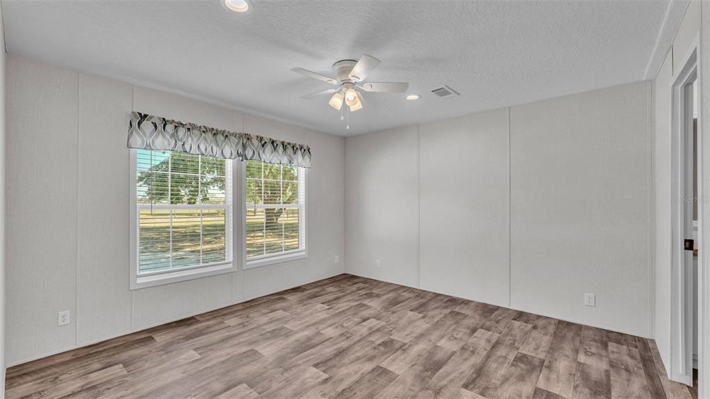 5535 Lake Buffum Road Lake Wales, FL 33859 - Photo 14 of 48 a view of an empty room with window and chandelier fan