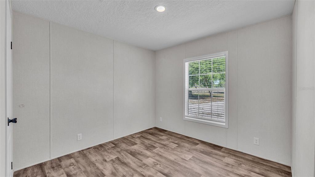5535 Lake Buffum Road Lake Wales, FL 33859 - Photo 21 of 48 a view of an empty room with wooden floor and a window