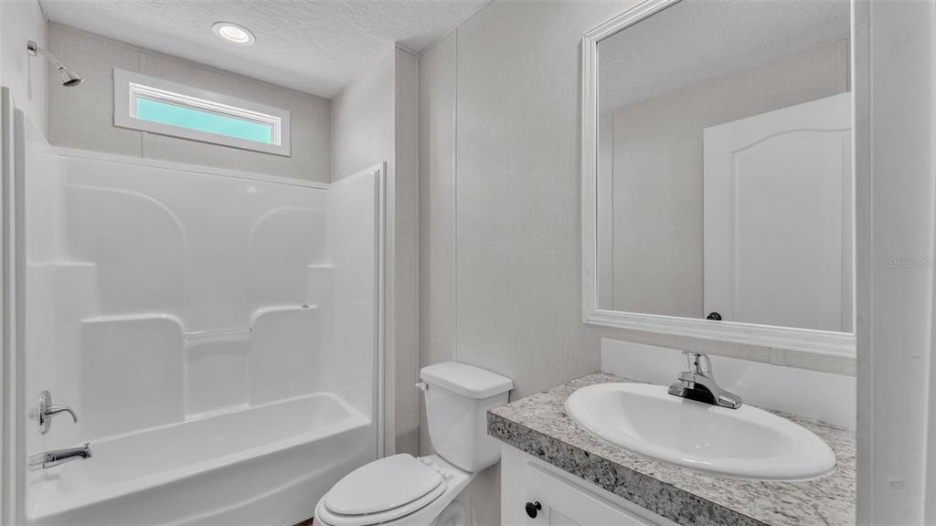 5535 Lake Buffum Road Lake Wales, FL 33859 - Photo 26 of 48 a bathroom with a granite countertop sink toilet and shower