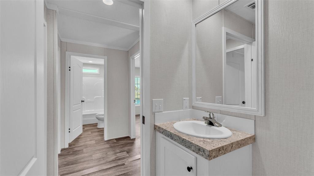 5535 Lake Buffum Road Lake Wales, FL 33859 - Photo 28 of 48 a bathroom with a granite countertop sink and a mirror