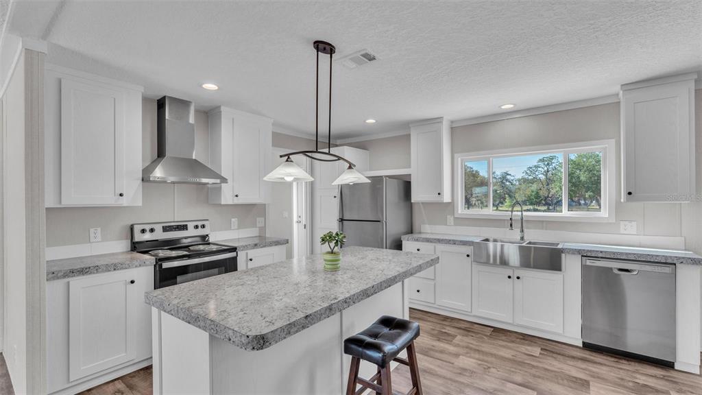 5535 Lake Buffum Road Lake Wales, FL 33859 - Photo 6 of 48 a kitchen with stainless steel appliances granite countertop a sink a stove and a refrigerator