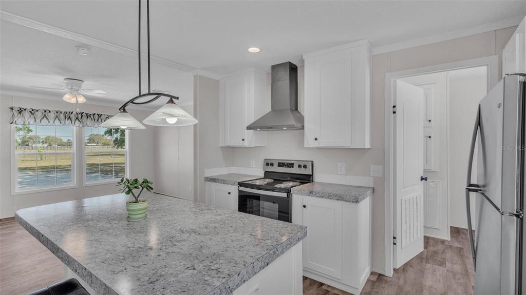 5535 Lake Buffum Road Lake Wales, FL 33859 - Photo 8 of 48 a kitchen with stainless steel appliances granite countertop a sink a stove and a refrigerator