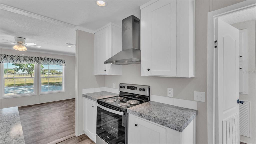 5535 Lake Buffum Road Lake Wales, FL 33859 - Photo 9 of 48 a kitchen with stainless steel appliances granite countertop a stove a sink and a refrigerator