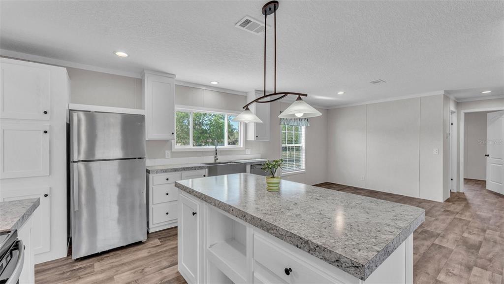 5535 Lake Buffum Road Lake Wales, FL 33859 - Photo 10 of 48 a kitchen with stainless steel appliances granite countertop a refrigerator a sink and a stove