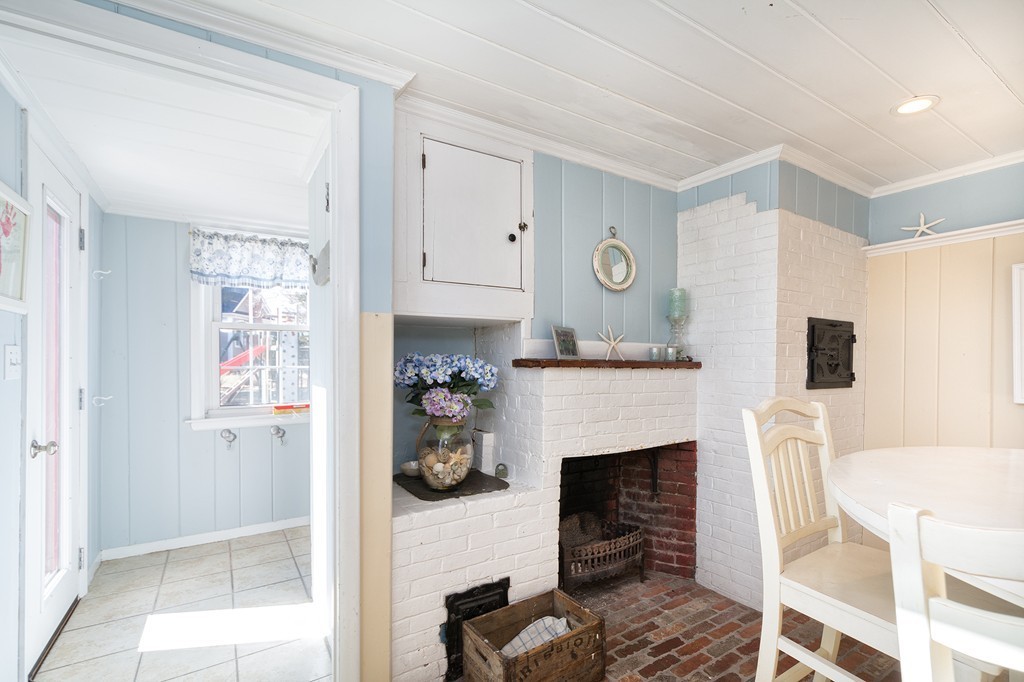 259 First Parish Road Scituate, MA 02066 - Photo 8 of 29 a living room with furniture and a fireplace